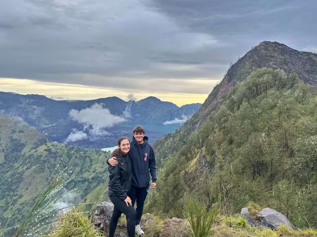 A couple standing at Mount Stampol crater rim, the best Rinjani alternative trek in Lombok