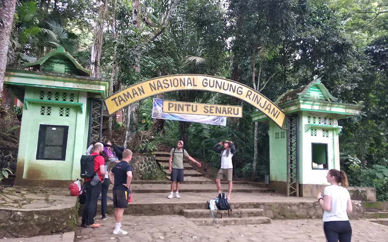 Group of people in front of a sign for Tambon National Park, ready for a 3D2N Mount Rinjani trek via Senaru route Group of people in front of a sign for Tambon National Park, ready for a 3D2N Mount Rinjani trek via Senaru route