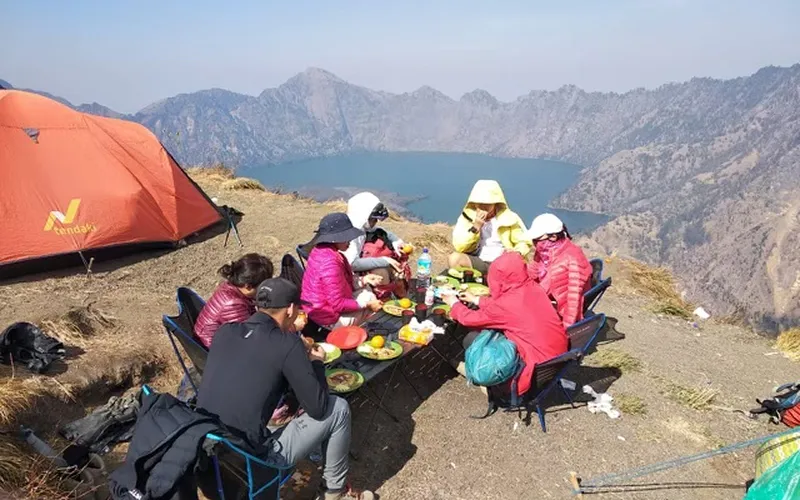 A group enjoying lunch on a mountain top during a 4-day hike on Mount Rinjani via the Senaru route A group enjoying lunch on a mountain top during a 4-day hike on Mount Rinjani via the Senaru route
