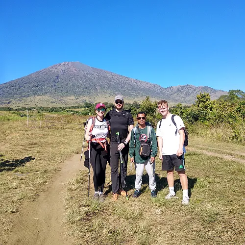 A group of hikers on a dirt path during the 2D1N Mount Rinjani hike, preparing to summit via the Sembalun route A group of hikers on a dirt path during the 2D1N Mount Rinjani hike, preparing to summit via the Sembalun route