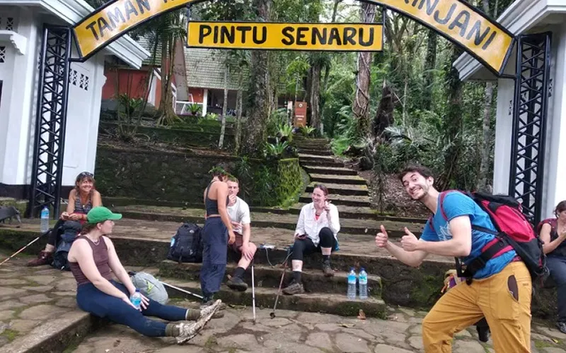 A group sits on steps beside a Pintu Sekali sign, gearing up for the Mount Rinjani hike at Crater Rim Senaru A group sits on steps beside a Pintu Sekali sign, gearing up for the Mount Rinjani hike at Crater Rim Senaru