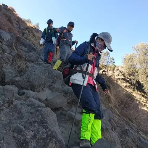A trio of hikers makes their way up a rocky path on Mount Rinjani during a four-day trek via the Senaru route A trio of hikers makes their way up a rocky path on Mount Rinjani during a four-day trek via the Senaru route