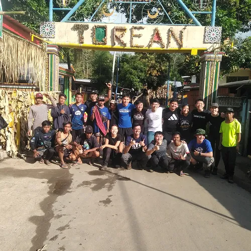 Friends pose happily in front of a Torean sign, ready to embark on a 3-day hike to the summit of Mount Rinjani Friends pose happily in front of a Torean sign, ready to embark on a 3-day hike to the summit of Mount Rinjani