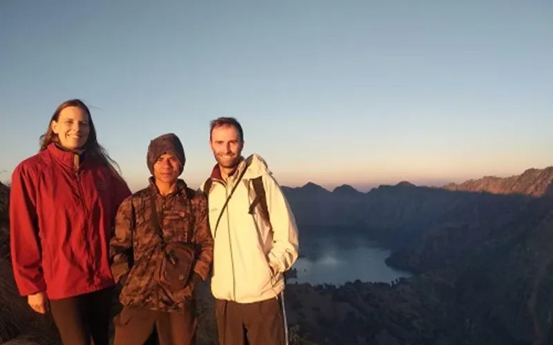 Three hikers celebrate at the summit of Mount Rinjani after a 4-day trek via the Senaru route Three hikers celebrate at the summit of Mount Rinjani after a 4-day trek via the Senaru route