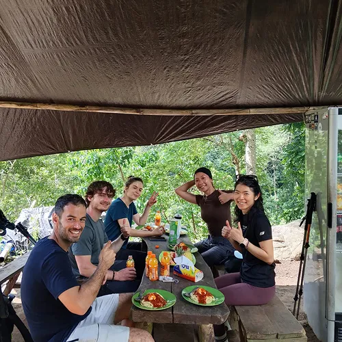 A group of hikers enjoying lunch at a table in the jungle during a Mount Rinjani trek on the Sembalun route A group of hikers enjoying lunch at a table in the jungle during a Mount Rinjani trek on the Sembalun route